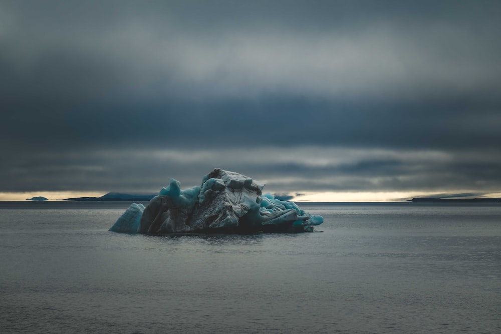 an iceberg floating in the middle of a body of water
