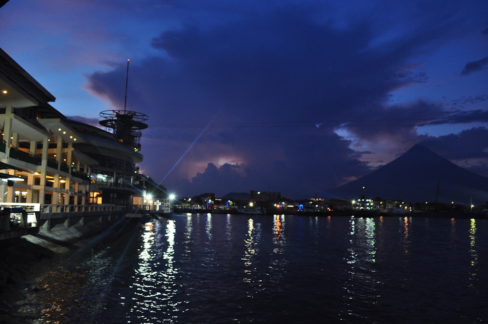 a large body of water next to a tall building