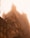 An imposing Gothic-style cathedral is shrouded in a heavy fog. The intricate architectural details such as pointed arches, spires, and decorative elements are somewhat obscured by the mist, creating a mysterious and ethereal atmosphere.