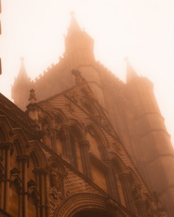 Fog moving through a desolate gothic cathedral ruin at twilight.