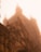An imposing Gothic-style cathedral is shrouded in a heavy fog. The intricate architectural details such as pointed arches, spires, and decorative elements are somewhat obscured by the mist, creating a mysterious and ethereal atmosphere.