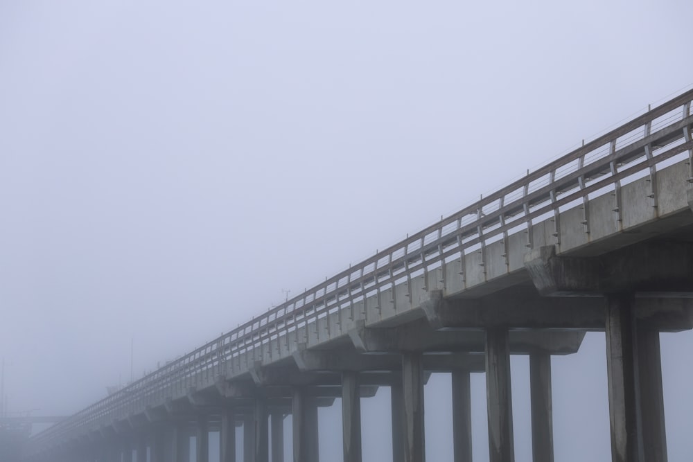 a foggy day with a long bridge in the distance