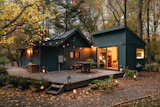 Two dark timber cabins with a lit deck at dusk