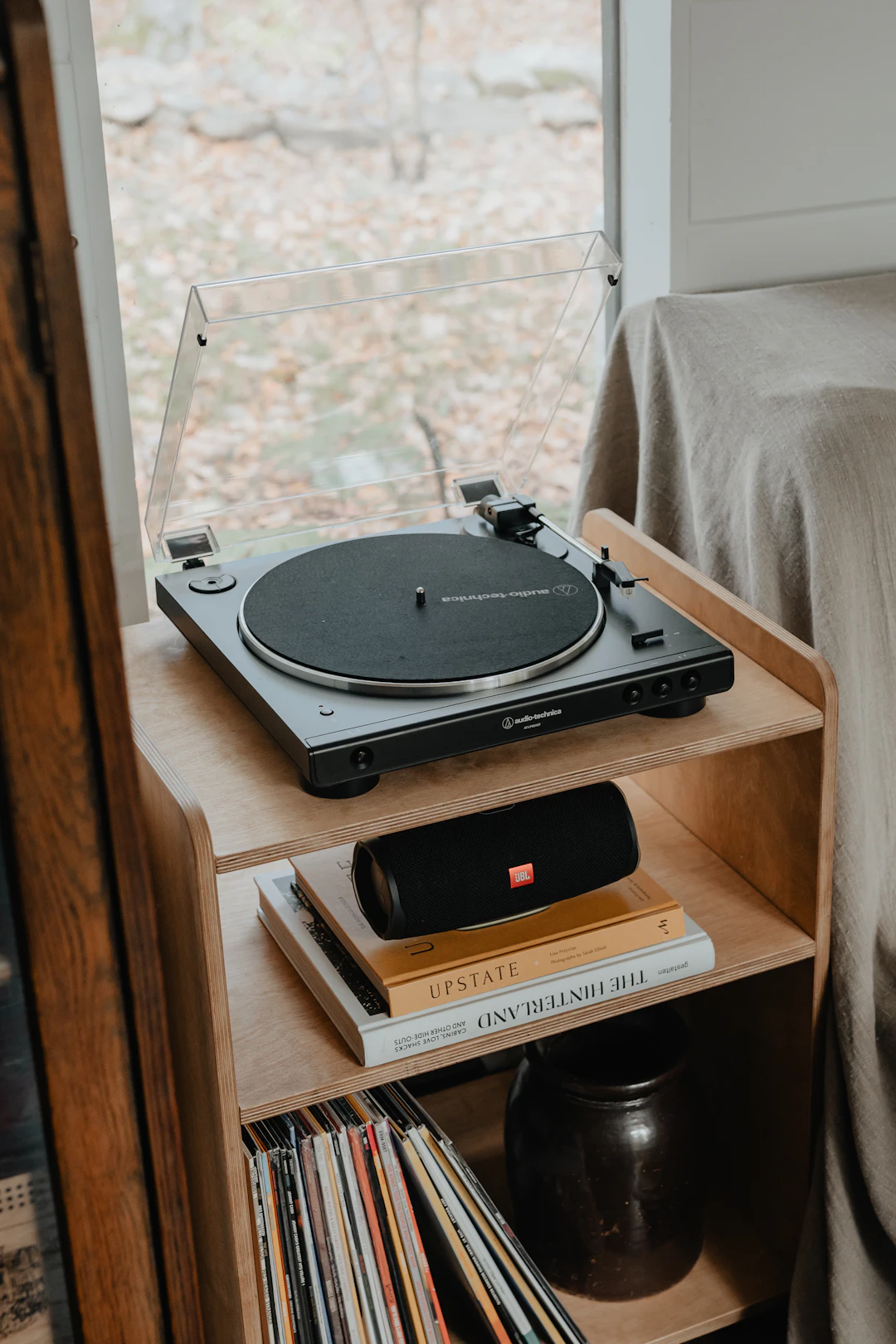 A record player on a wooden shelf