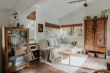 a living room filled with furniture and lots of windows