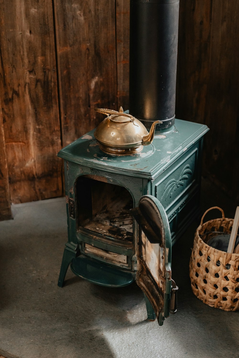 a green stove with a pot on top of it