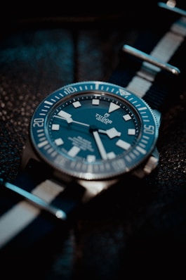 a watch sitting on top of a black table