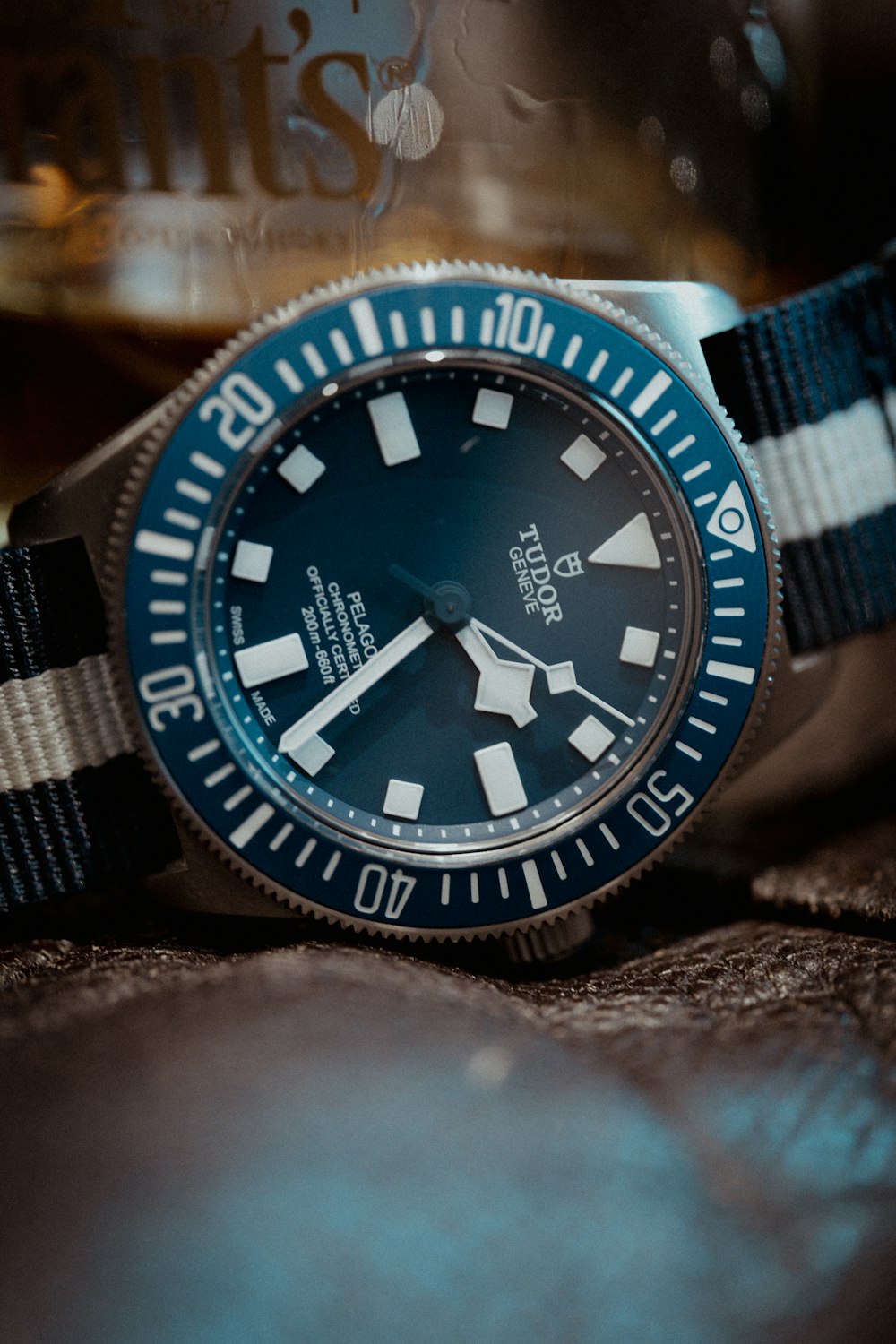 a blue and white watch sitting on top of a bed