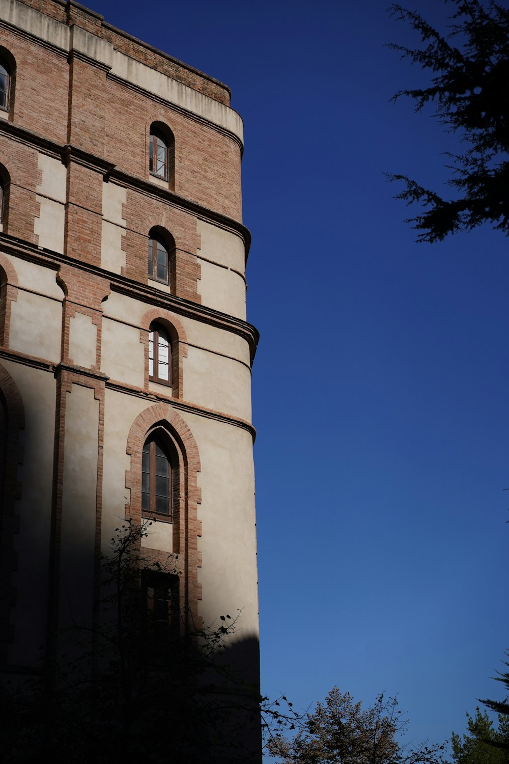 a tall brick tower with a clock on it's side