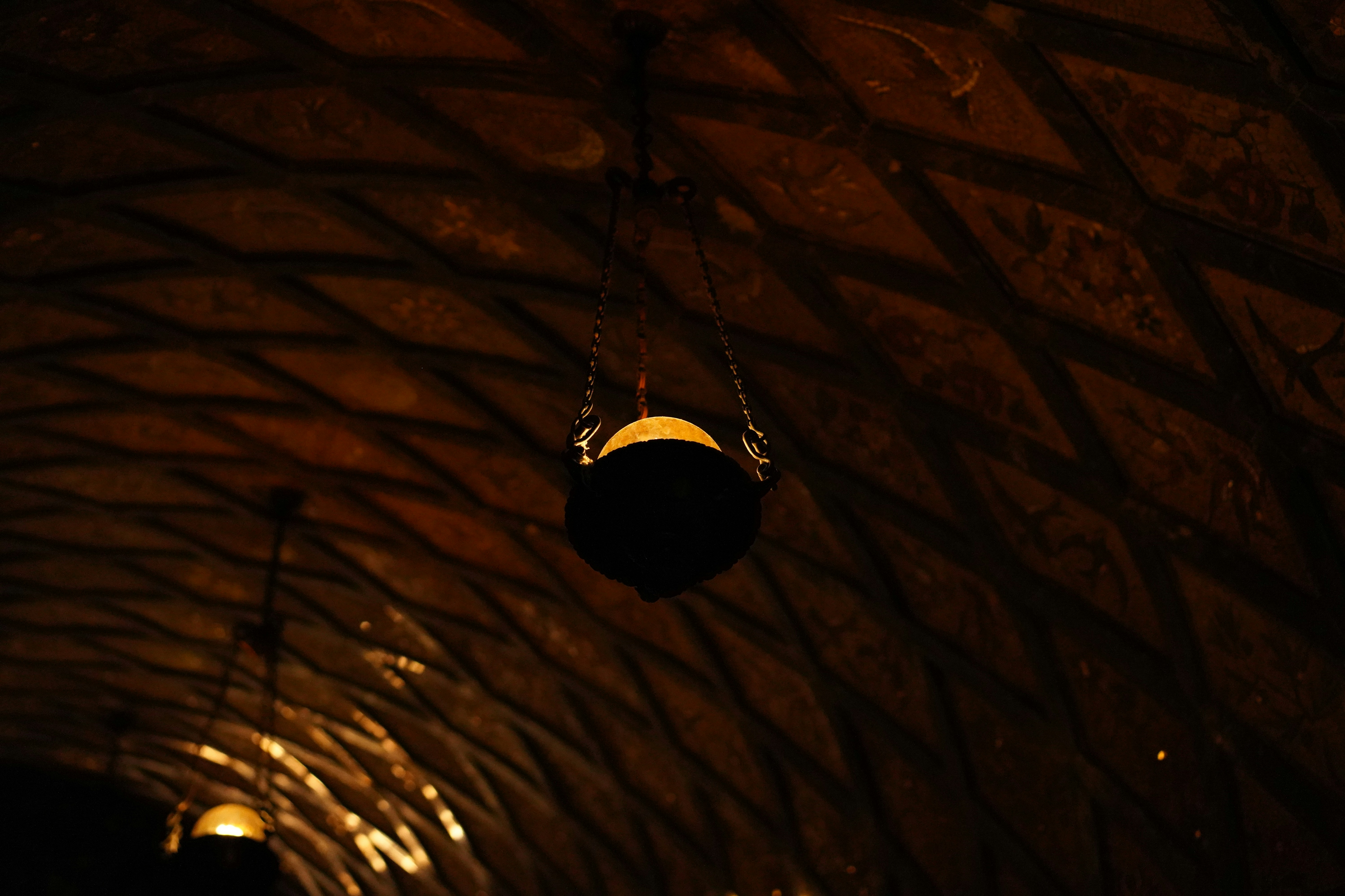 a light hanging from the ceiling of a building