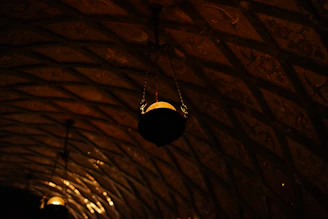 Close-up of textured ceiling panels with warm lighting highlighting their intricate design.