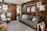 A cozy living room featuring elegant wall coverings and stylish wooden furniture.