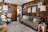 A cozy living room featuring elegant wall coverings and stylish wooden furniture.