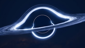 A mesmerizing cosmic scene featuring a black hole with a brightly illuminated accretion disk forming a halo-like structure around it. The surrounding space appears dark, enhancing the glowing white and blue hues of the disk that swirls and bends light around the black hole.