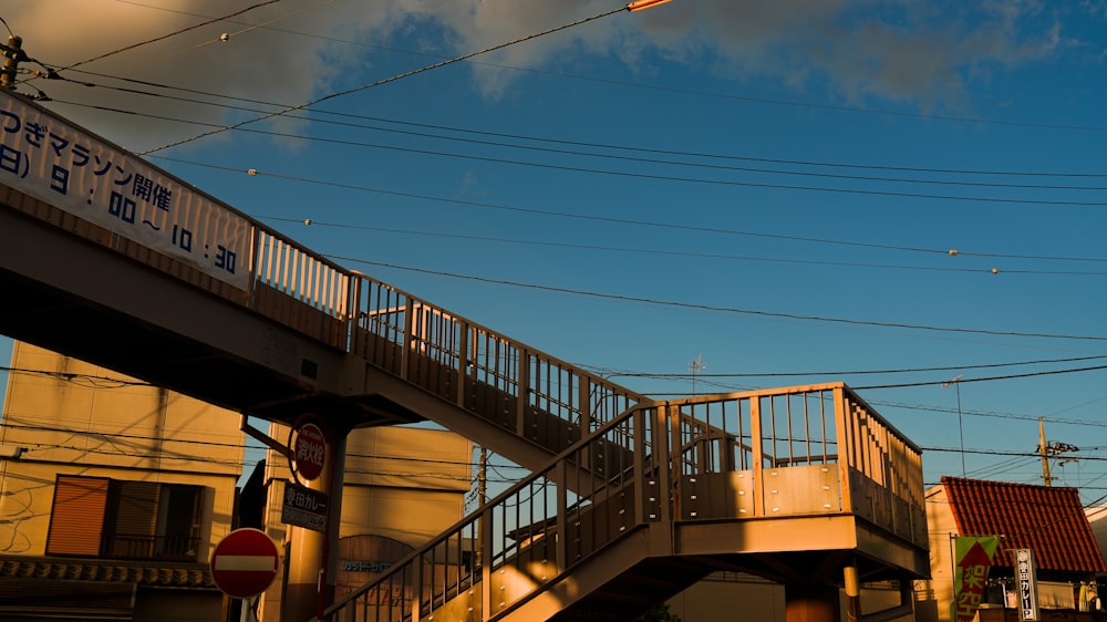 a train traveling over a bridge over a street