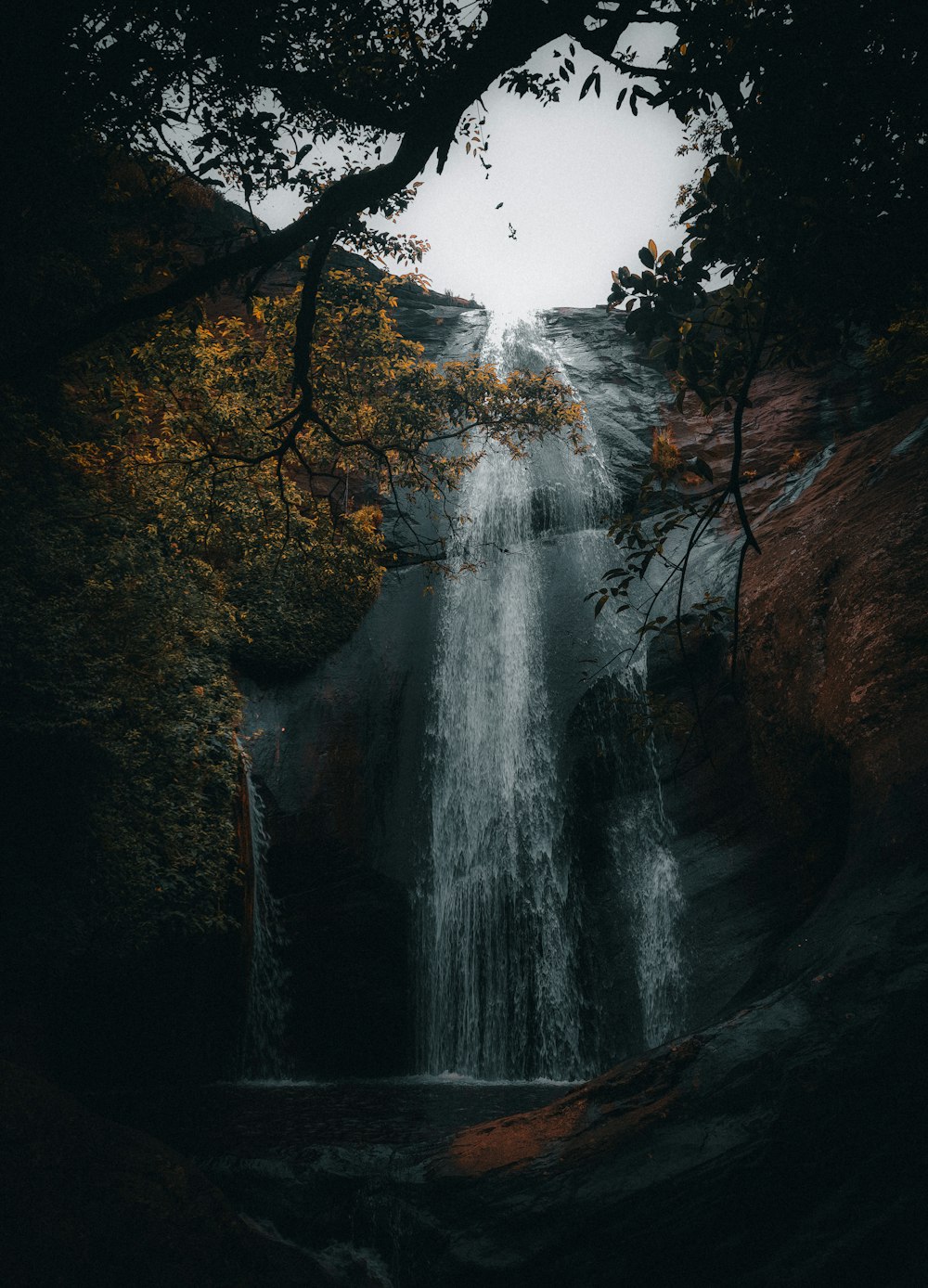 a waterfall in the middle of a forest