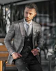 A stylish man wearing a bright Lebrune shirt walking confidently in an office setting.