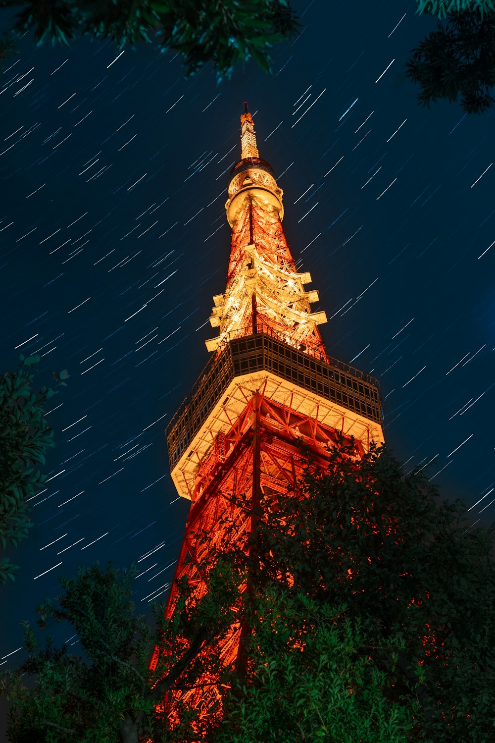 the eiffel tower is lit up at night