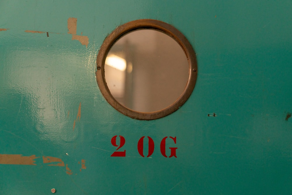 a close up of a door with a round window