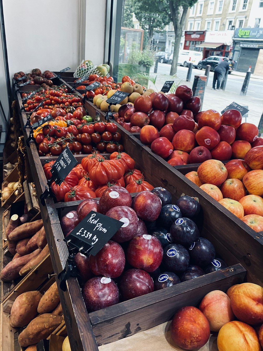 a display of fruits and vegetables in wooden boxes