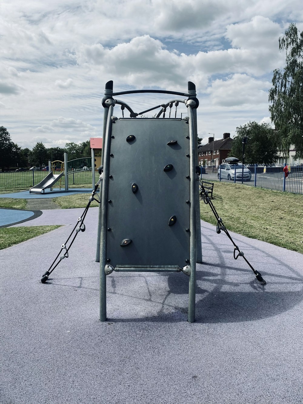 a playground with a climbing frame and a slide