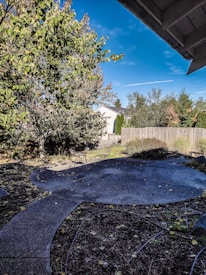 Before and after photos of a clean, junk-free backyard space.