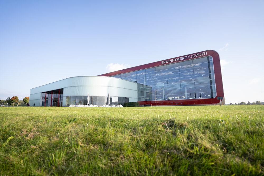 a large building sitting on top of a lush green field