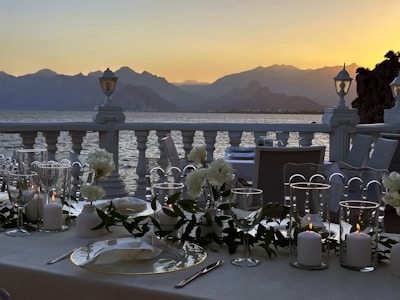 A beautifully arranged gourmet dining setup overlooking a serene mountain view.