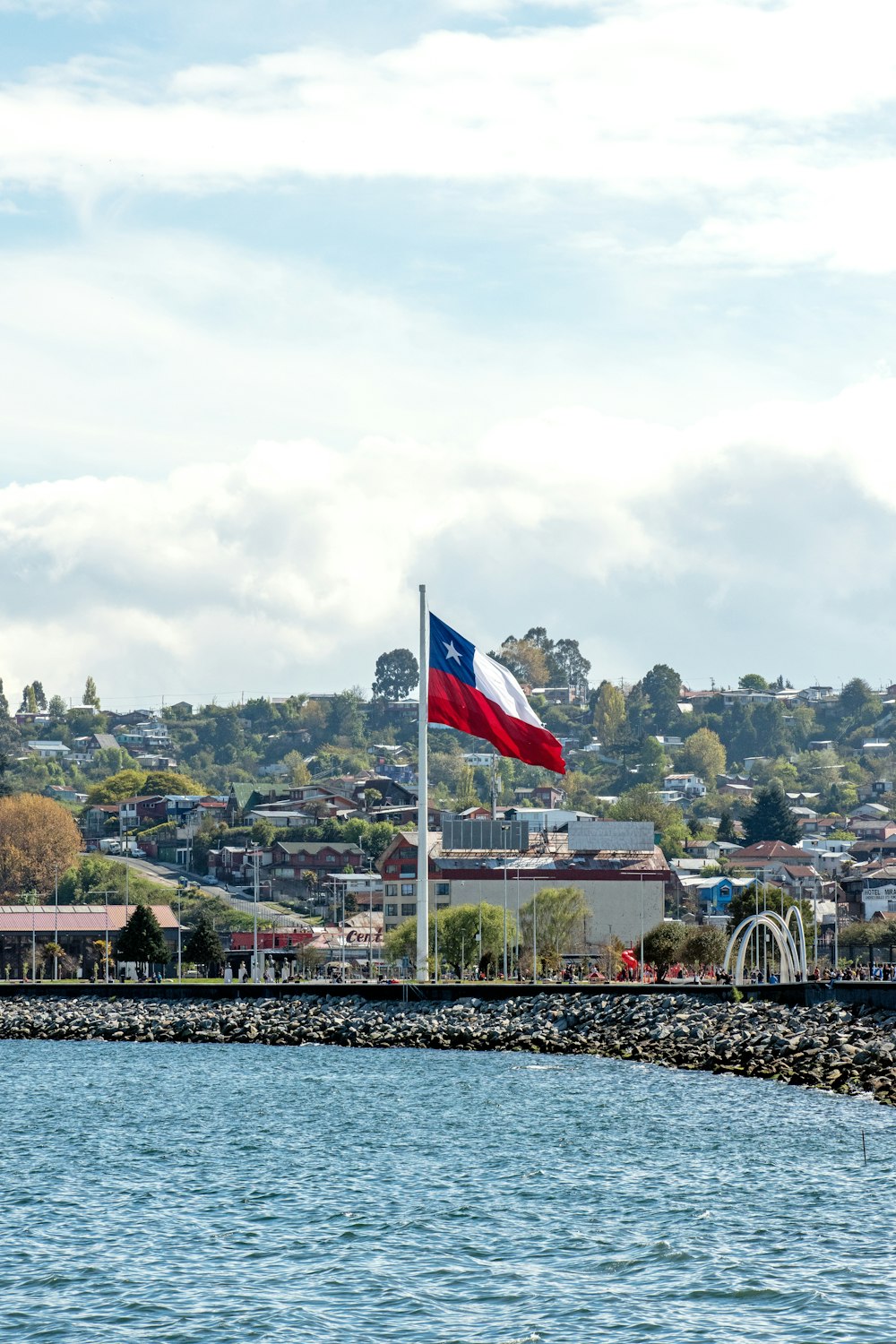 a flag flying over a body of water