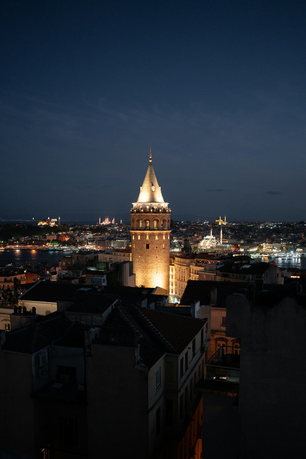 a view of a city at night from a rooftop