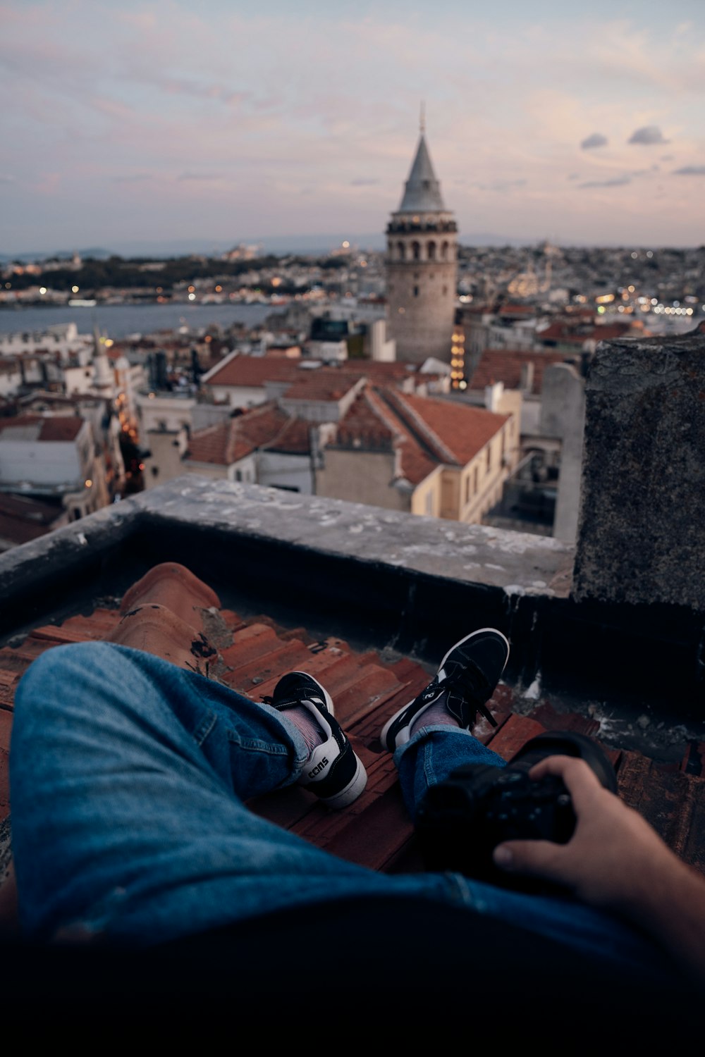 a person laying on top of a roof with their feet up