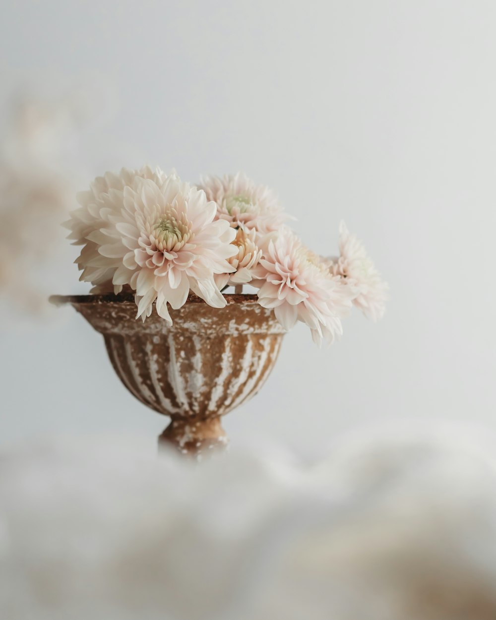 a vase filled with pink flowers on top of a table