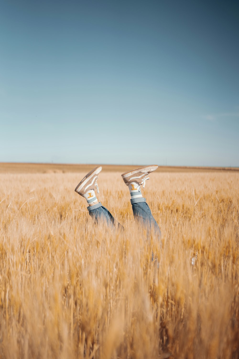 a couple of people that are laying down in a field