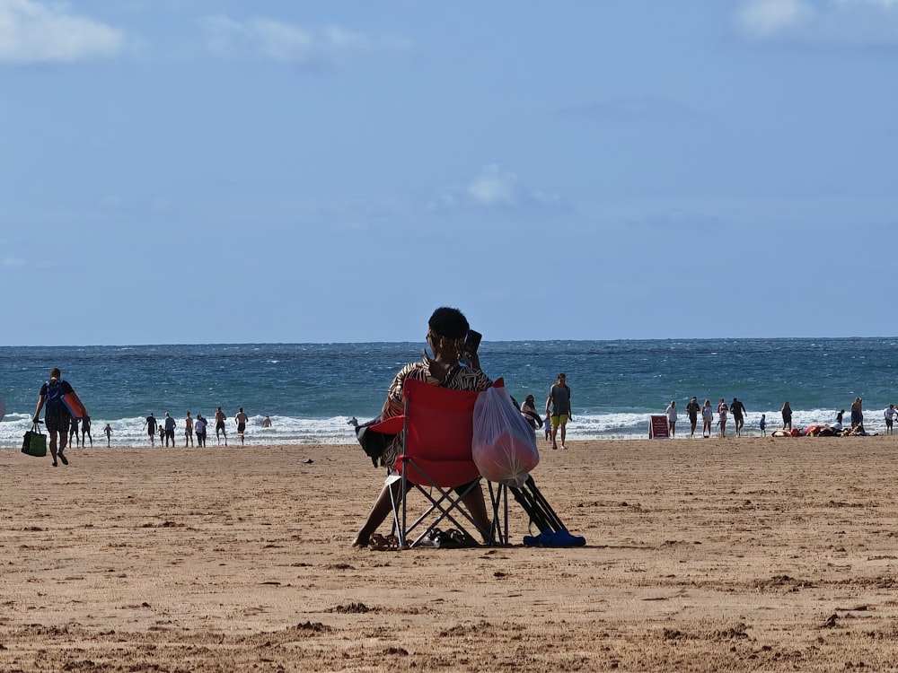 a person sitting in a chair on a beach