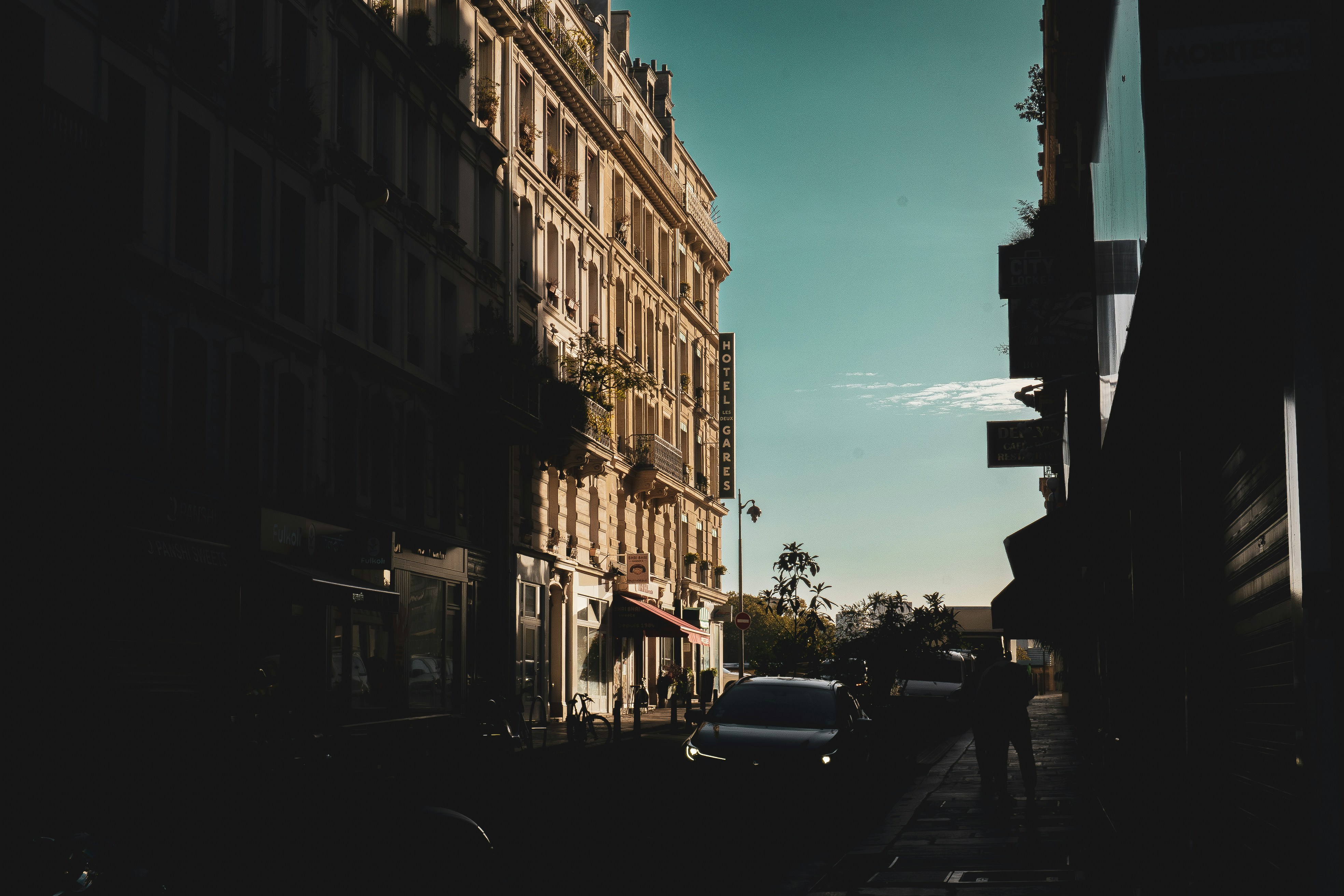 a city street with cars parked on the side of it, View from Hotel Damiens to Gare de l´Est train station in Paris, France. October 2023.