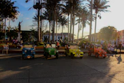 a group of children's vehicles parked on the side of a road