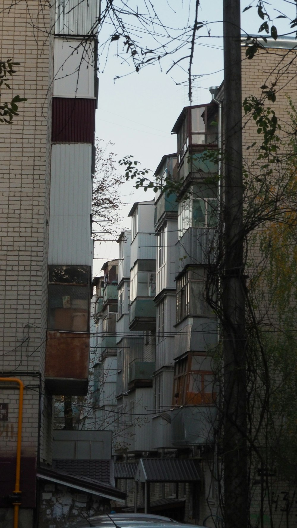 a car parked on the side of a road next to tall buildings