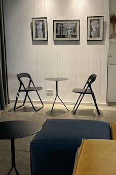 A stylish folding table folded neatly against a wall in a small apartment.