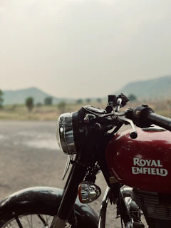 Close-up of the Royal Enfield Himalayan’s rugged front fork and headlamp under a clear blue sky.