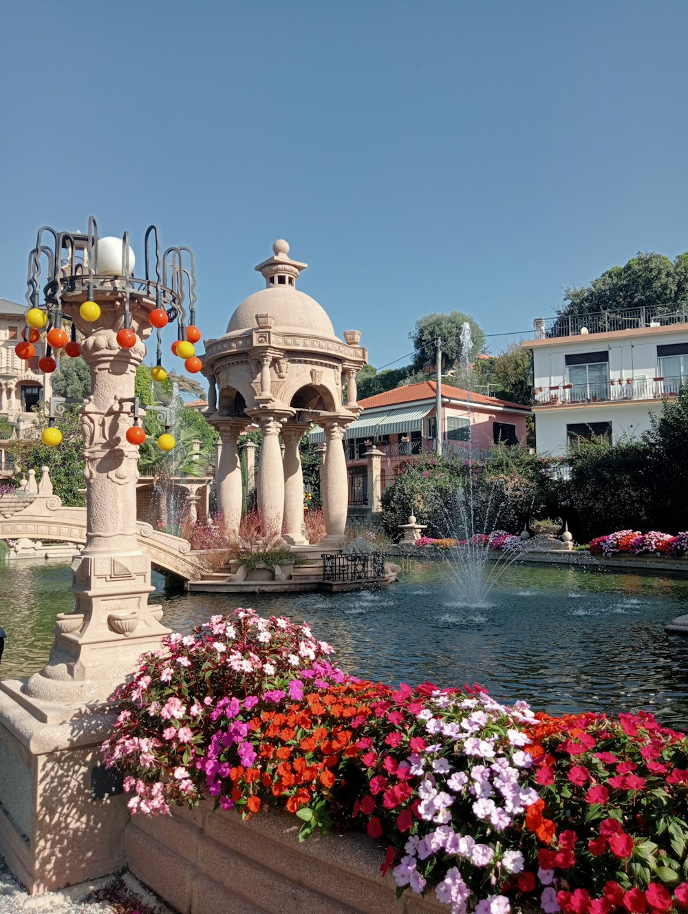 ein von Blumen umgebener Brunnen in einem Park