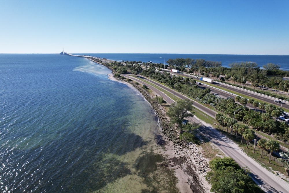 an aerial view of a highway and the ocean