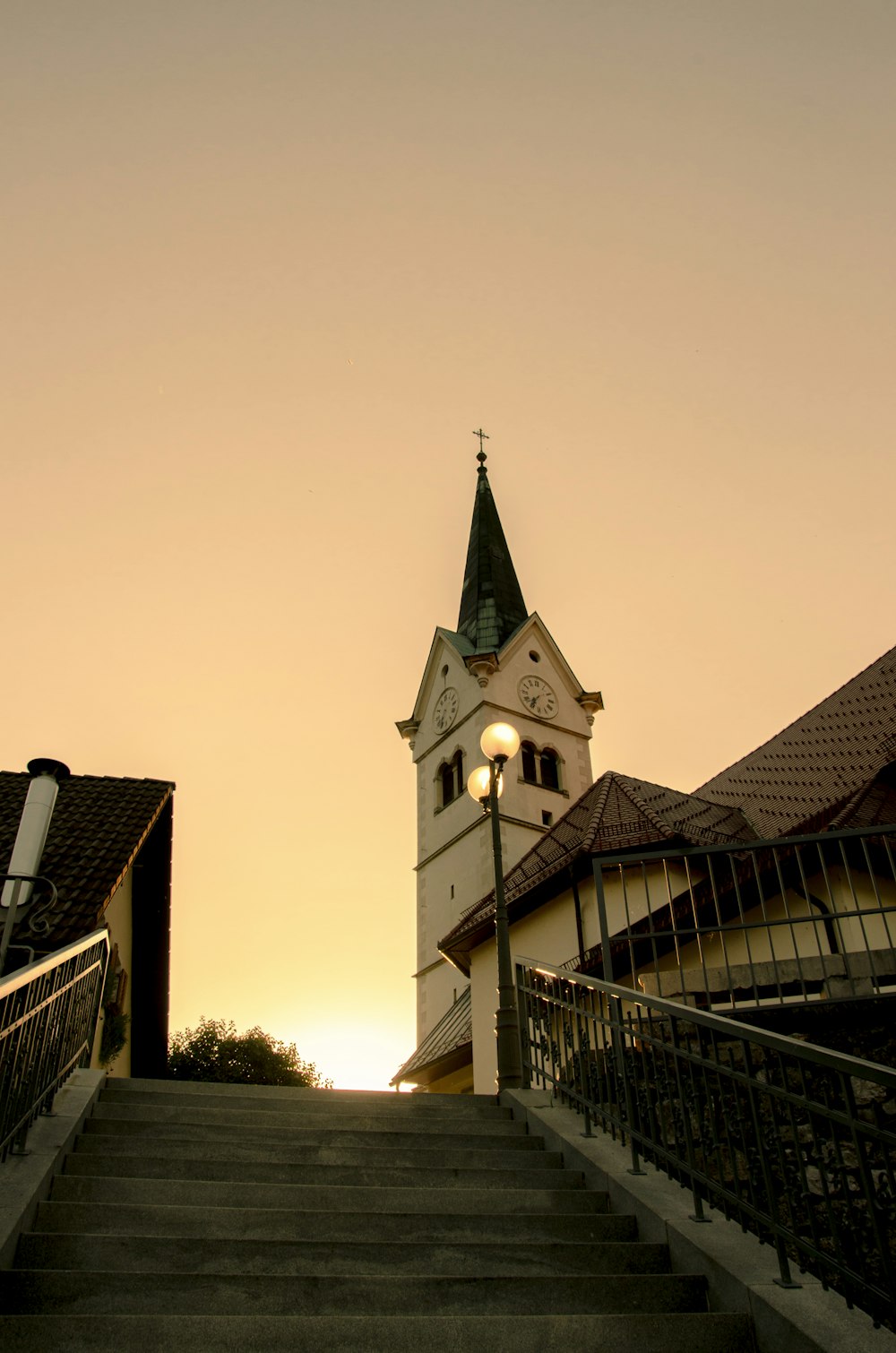 a church steeple with a clock tower in the background