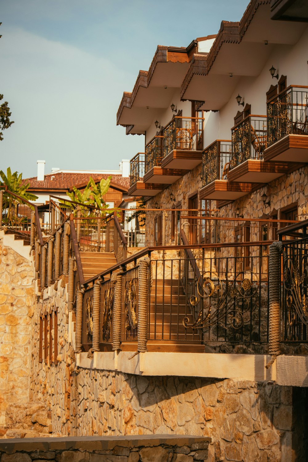 a stone building with balconies and railings