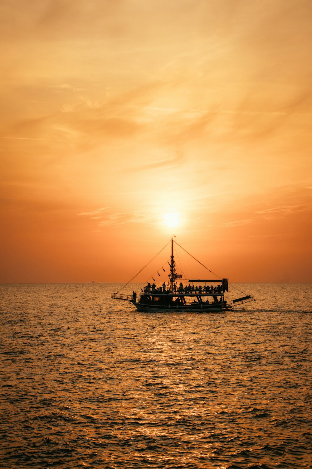 a boat is in the water at sunset