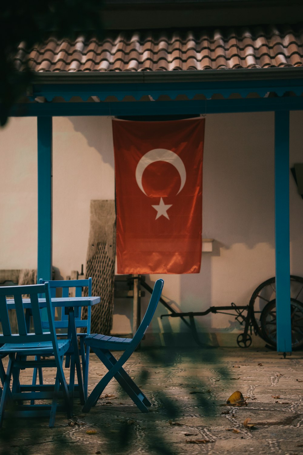 a flag hanging on a wall next to chairs