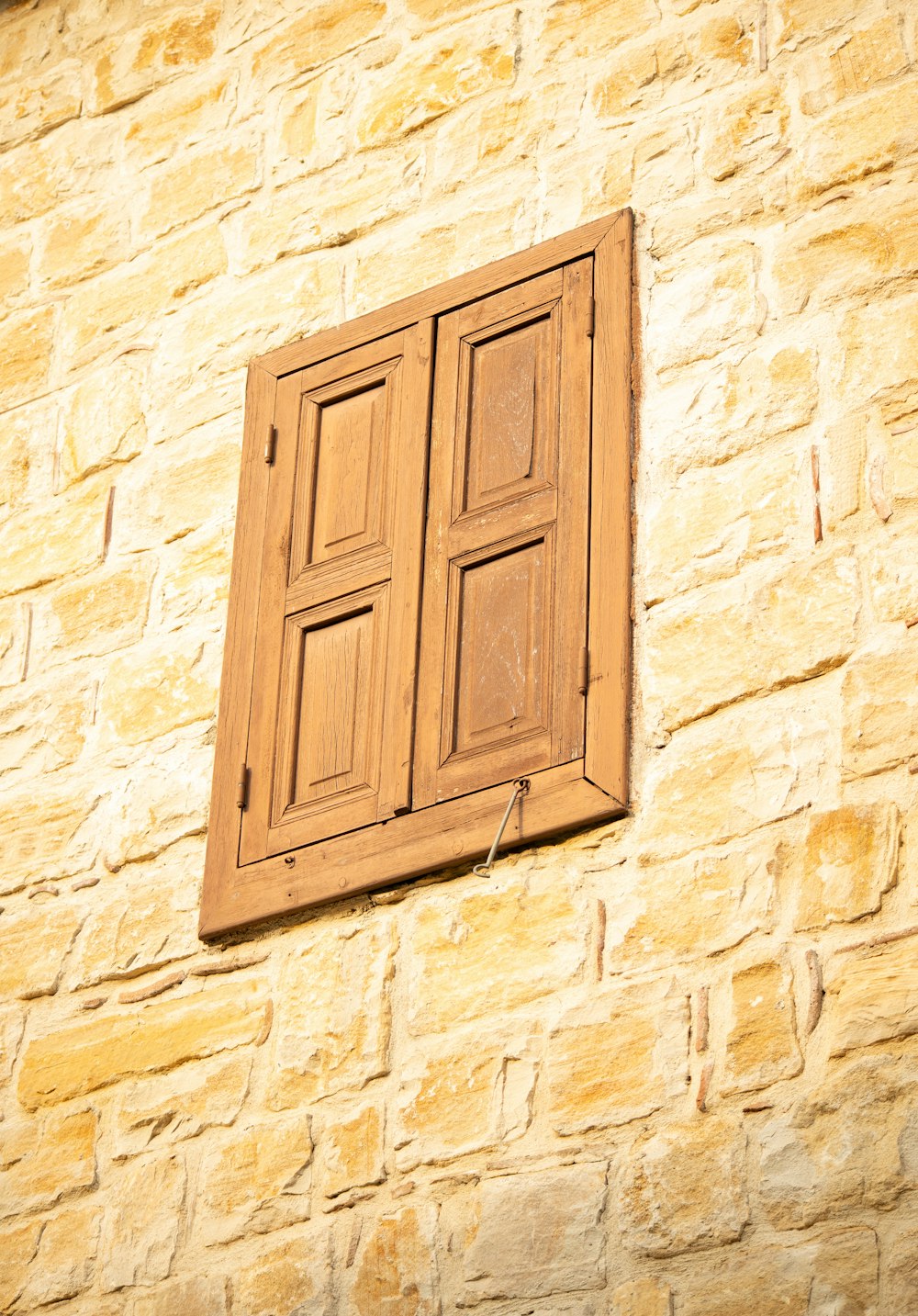 a close up of a window on a brick wall