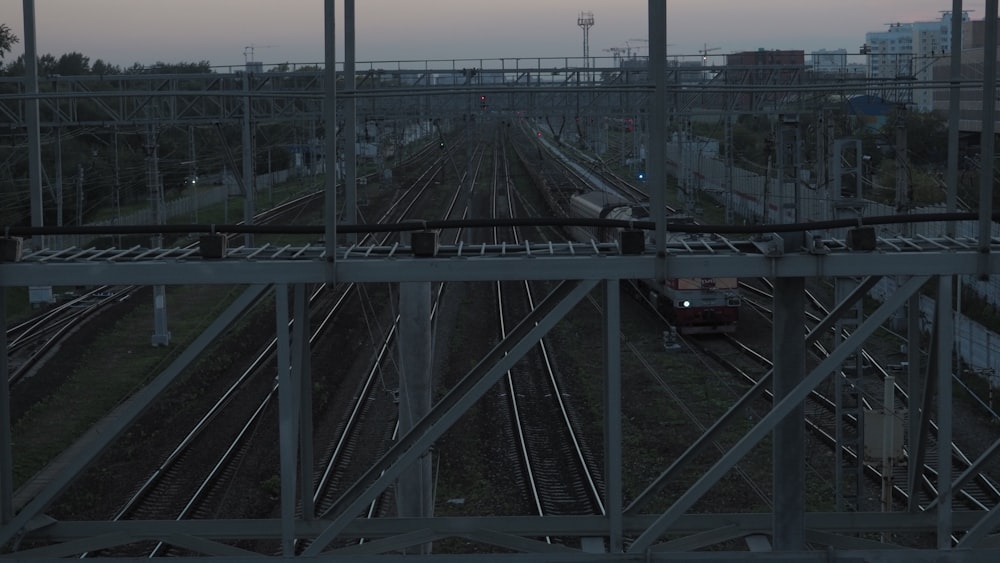 a train traveling down train tracks next to a tall building