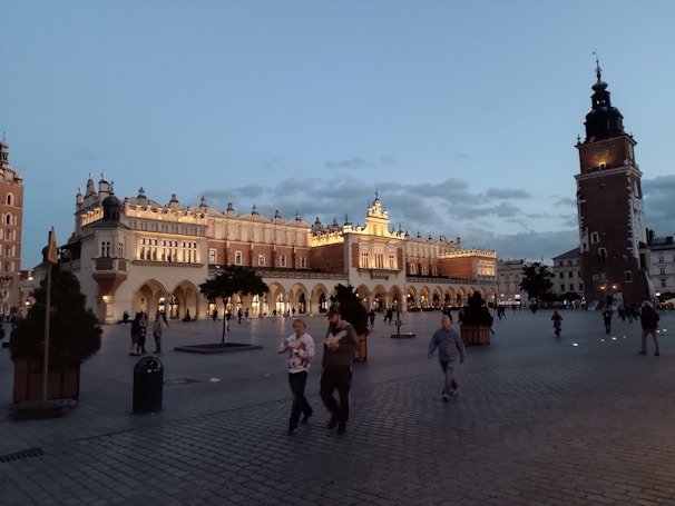A panoramic view of Kraków's historic market square bustling with tourists.
