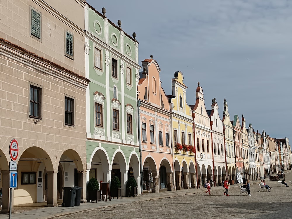 a row of buildings with people walking on the sidewalk