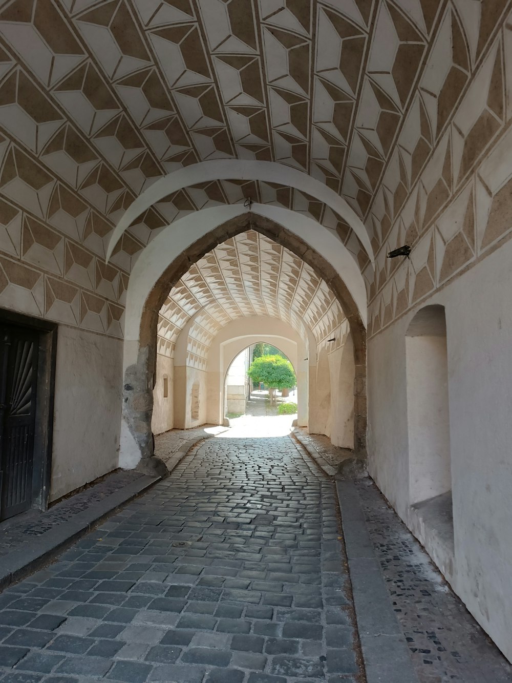 a tunnel with a clock on the side of it